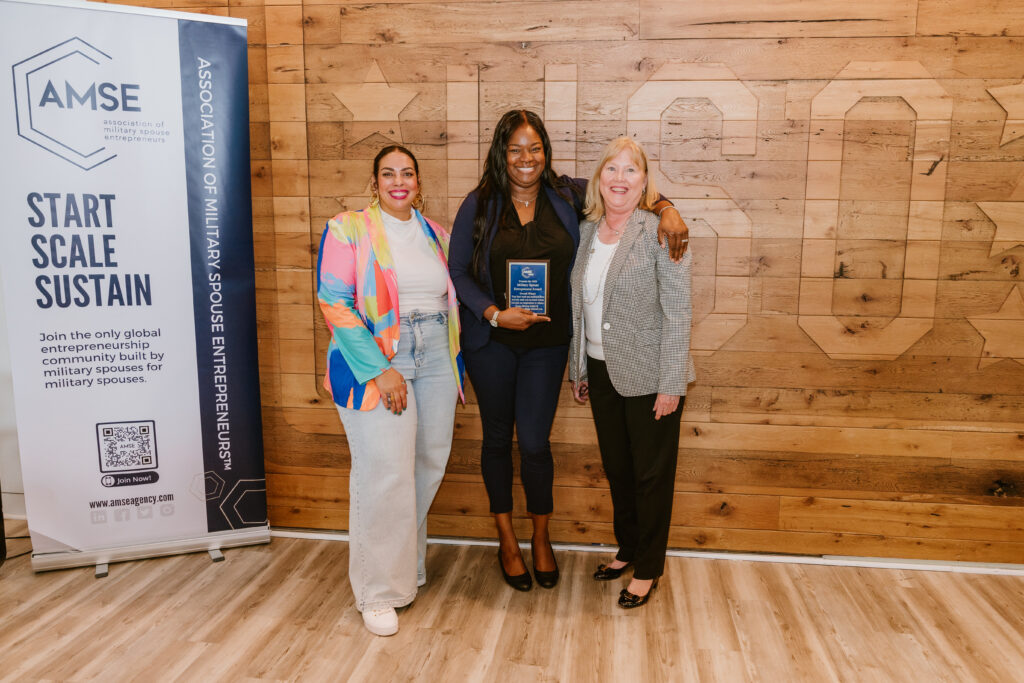 Simone Atkinson, founder of Kid-Friendly Tours, a travel agency specializing in crafting adult-centric itineraries with thoughtful accommodations for children, holding her award as military spouse entrepreneur winner