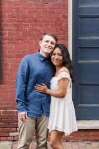 A sweet, classic portrait of the couple standing together, the woman leaning gently on her partner.